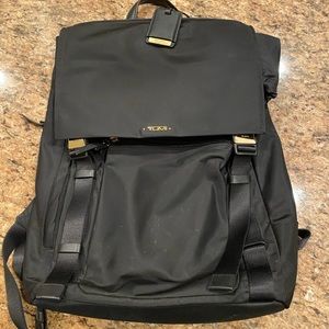 Tumi women work backpack with laptop section. Gold metal, vinyl material